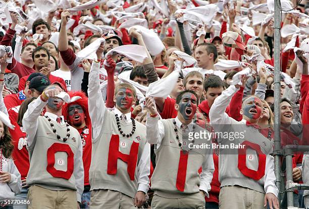 Ohio State Buckeyes fans dressed like head coach Jim Tressel cheer on their team against the Michigan Wolverines on November 20, 2004 at Ohio Stadium...