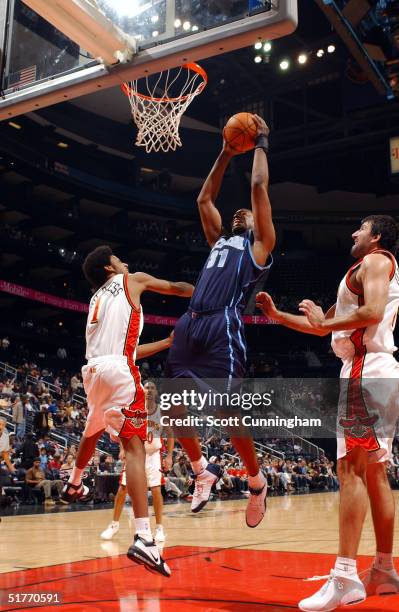 Jarron Collins of the Utah Jazz grabs a rebound in traffic against Josh Childress of the Atlanta Hawks during a game on November 20, 2004 at Philips...