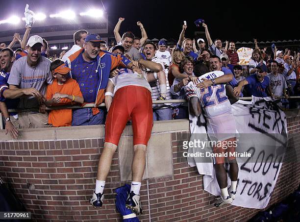 Players from the University of Florida Gators jump into the stands after their team's 20-13 win over the Florida State Seminoles at Doak Campbell...