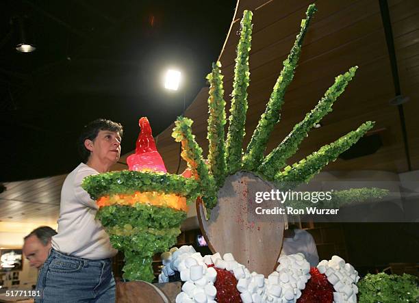 Janet Donaldson works on securing the crown to a gingerbread and candy reproduction of the Statue f Liberty for a contest based on the theme "Miracle...