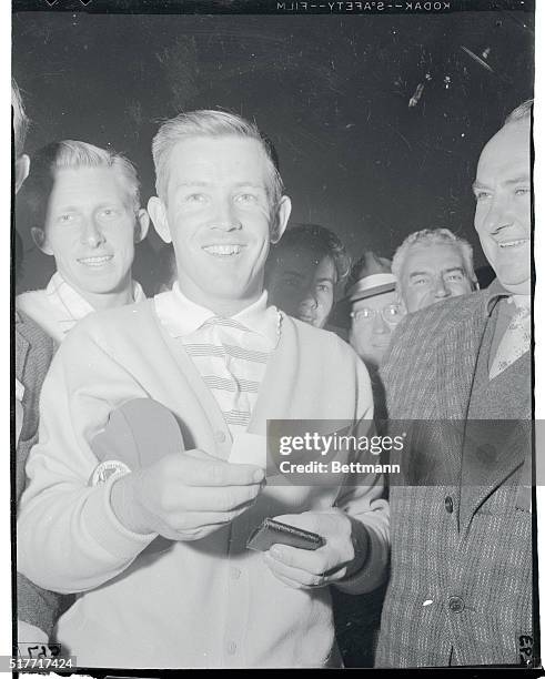 Gene Littler, the blond bomber of the links, gives his $5,000 check for winning the Los Angeles Open a playful buss. The 23 year old former National...