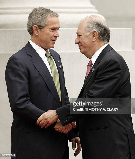 President George W. Bush is greeted by Chilean President Ricardo Lagos as he arrives at the La Moneda Palace in Santiago, Chile 21 November 2004....