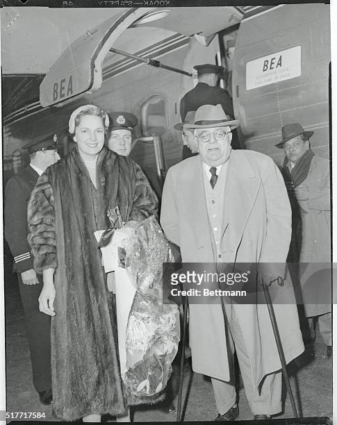 With unconcerned smiles, the Agha Khan III and his beautiful Beghum walk from a Bea Airliner which brought them to the Eternal City with one of its...