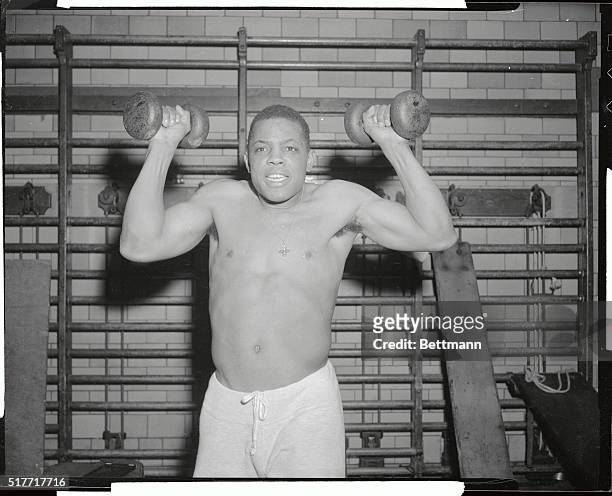 Looking more like a pugilist than the baseball great he is, Willie Mays of San Francisco Giants gets in a strenuous workout here at the Harlem YMCA....