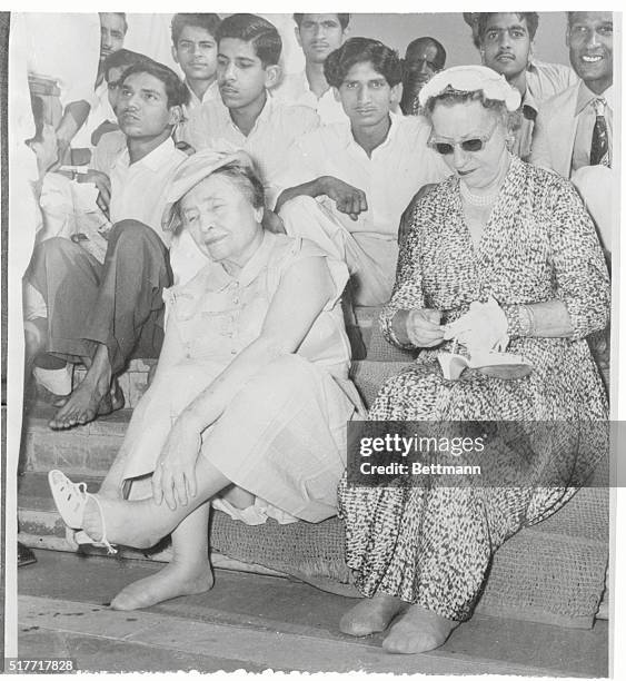 Helen Keller at Gandhi Shrine. New Delhi, India: Helen Keller, world famous blind and deaf author, who is currently touring India, is shown removing...