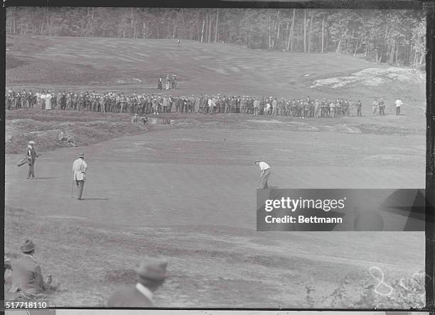 Brookline, MA-Spectators watch players, Ray and Hobens with caddie on putting green at the US Open.