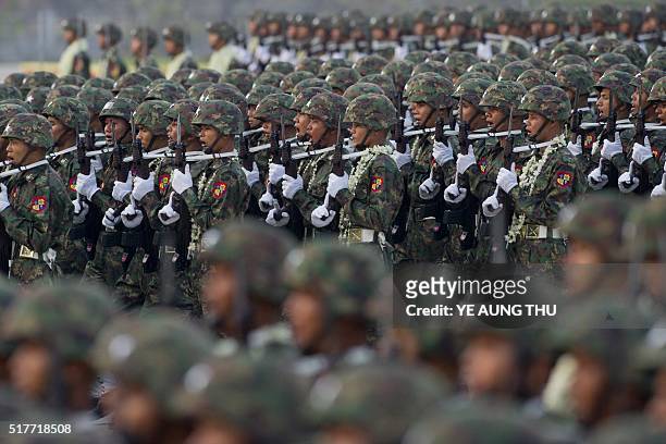 Members of Myanmar's military march in formation during a ceremony to mark the 71st Armed Forces Day in Myanmar's capital Naypyidaw on March 27,...