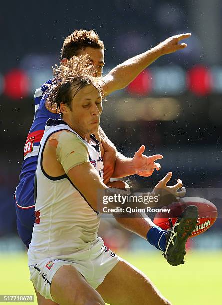 Cameron Sutcliffe of the Dockers and Luke Dahlhaus of the Bulldogs compete for a mark during the round one AFL match between the Western Bulldogs and...
