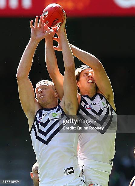Jonathon Griffin and Nathan Fyfe of the Dockers compete with each other for a mark during the round one AFL match between the Western Bulldogs and...