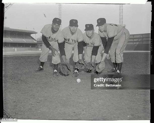 Crouching ready to "scoop one up" are four Giant infielders, raring to go, as the 1954 World Series approaches. The September 29th series opener...