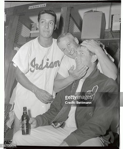 Cleveland Indians' pitcher Bob Lemon is congratulated by teammate Al Rosen in the dressing room after Lemon won his 22nd game of the season by...