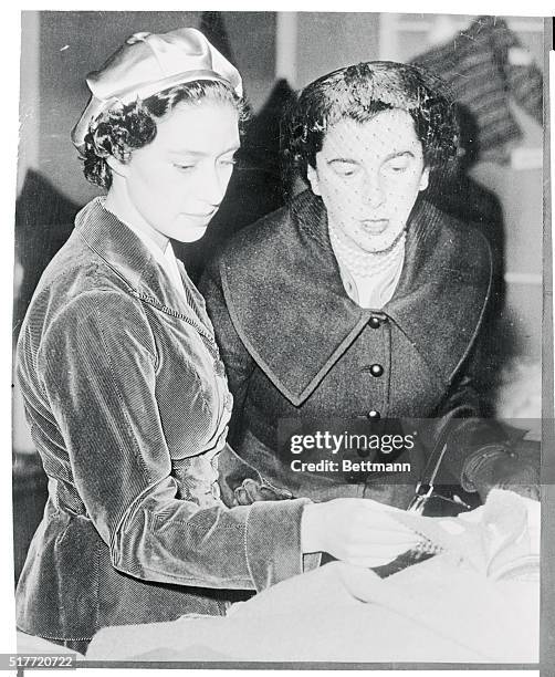 Britain's Princess Margaret inspects goods made in the Scottish Highlands at an exhibition in London. She ordered a suit-length handwoven tweed for...