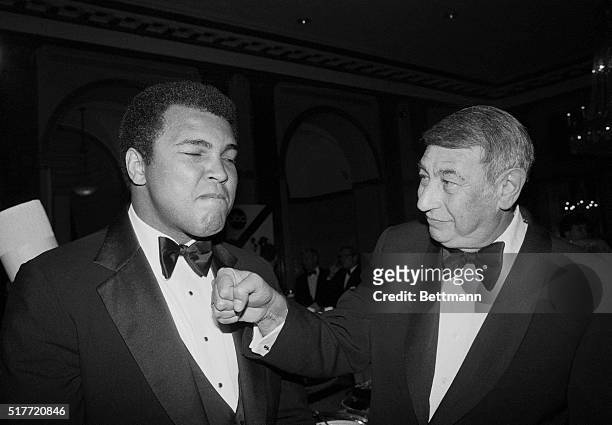 Sportscaster Howard Cosell playfully socks former heavyweight champ Muhammad Ali in this photograph, during a dinner celebrating the 20th anniversary...