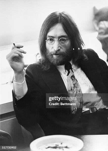 Musician John Lennon of the Beatles relaxing with a cigarette.