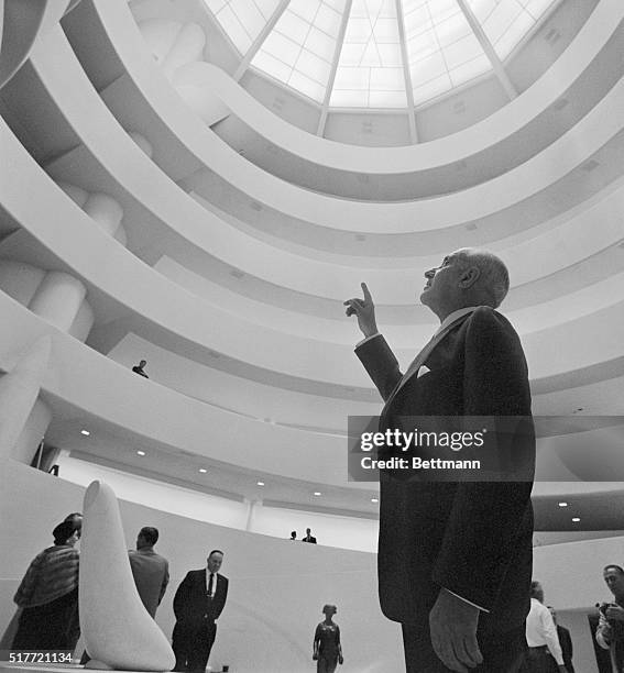 The Guggenheim Museum at 1071 5th Avenue is shown with Harry F. Guggenheim, as he points to a glass dome designed by Frank Lloyd Wright.