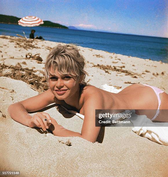 Brigitte Bardot, originally Camille Javal, actress, pictured here on a towel, sunning on the beach.