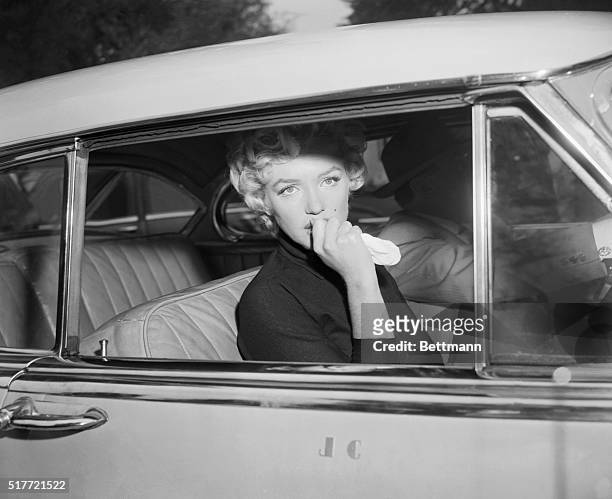 Marilyn Monroe leaves the home she briefly shared with Joe Di Maggio in a car driven by her attorney, Jerry Giesler. Monroe had just announced her...