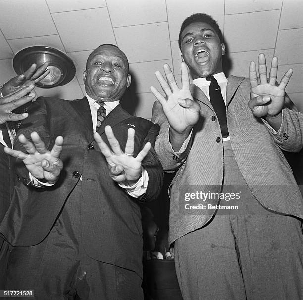 Pugilist-poet Cassius Clay and bandleader Lionel Hampton are in high spirits as they raise eight digits to indicate - according to their optimistic...