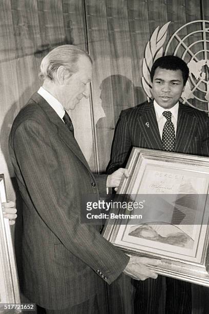United Nations- United Nations Secretary-General Kurt Waldheim accepts one of two "paintings for peace" from and executed by world heavyweight boxing...