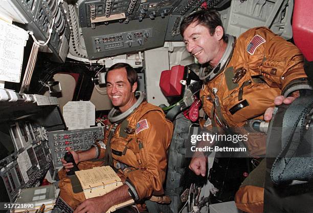 Kennedy Space Center, Florida: Prime crew astronauts for the first space shuttle mission, Commander John Young and pilot Robert Crippen, take a break...