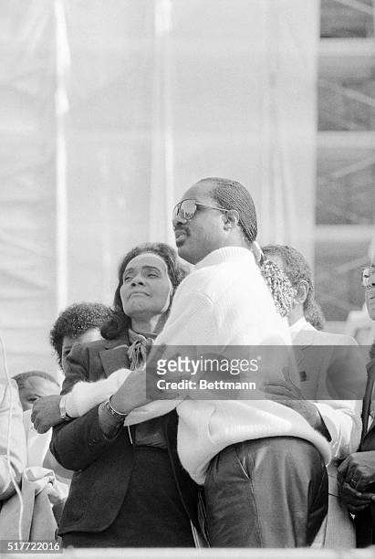Washington. Singer Stevie Wonder embraces Coretta King in the Rose Garden at the White House during ceremonies at which President Reagan signed a...