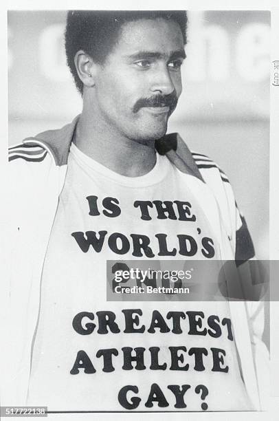 Gold medal winner for the decathalon, Daley Thompson of Great Britain, shows off one of his message t-shirts at a news conference after he won the...