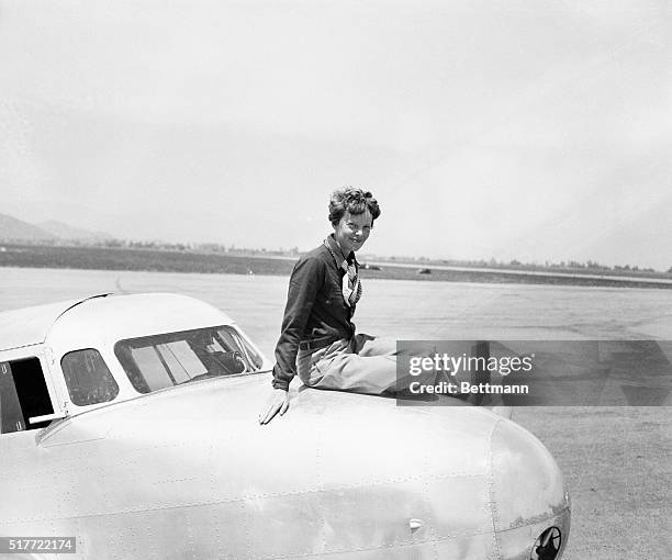 California: Sitting On Top Of The World . Amelia Earhart Putnam, America's ace woman flyer, seated atop the cockpit of the twin-motored, all-metal,...