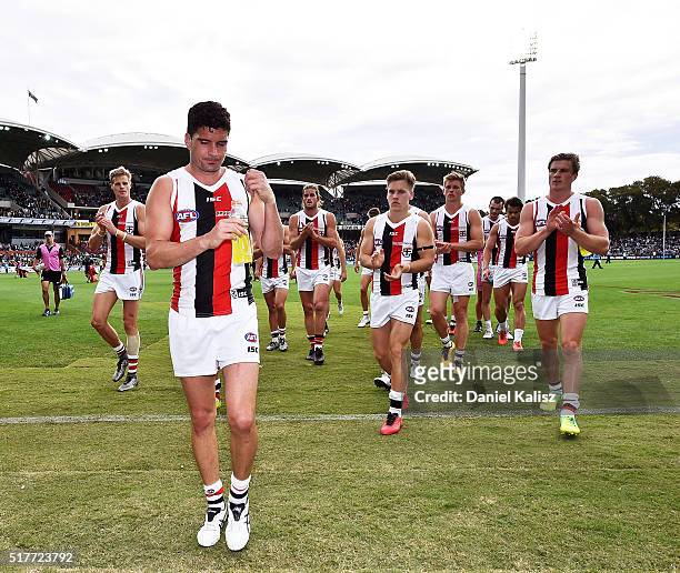 Leigh Montagna of the Saints leads his team mates from the fielf after the round one AFL match between the Port Adelaide Power and the St Kilda...