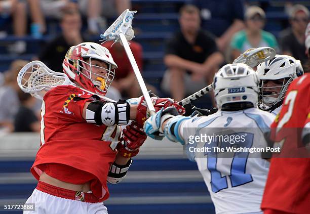 Maryland's Connor Kelly shoots between North Carolina players in the second half in the NCAA quarterfinal game at Navy Marine Corps Memorial Stadium...