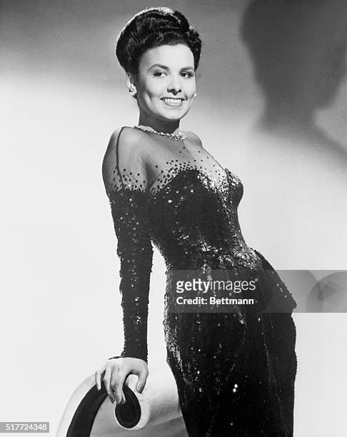 Lena Horne, prominent singer of jazz who is also an actress, poses in a sequined gown.