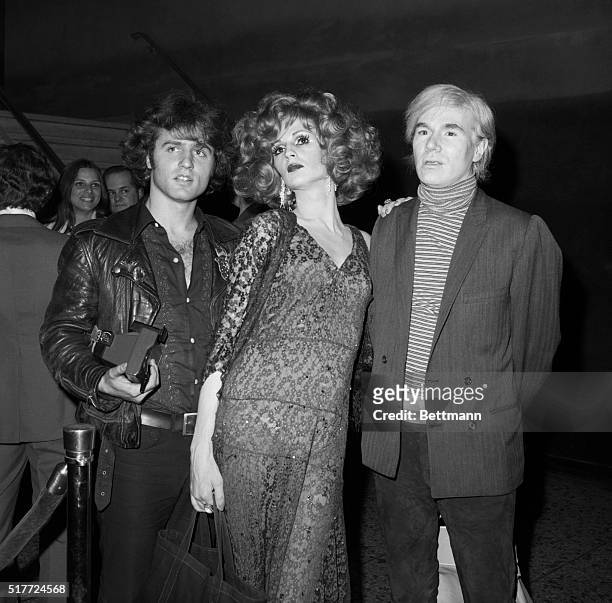 POP ARTIST AND UNDERGROUND FILM MAKER ANDY WARHOL IS ACCOMPANIED BY TWO OF HIS SUPERSTARS, CANDY DARLING AND GERARD MALANGA, AS THEY ARRIVE AT A...