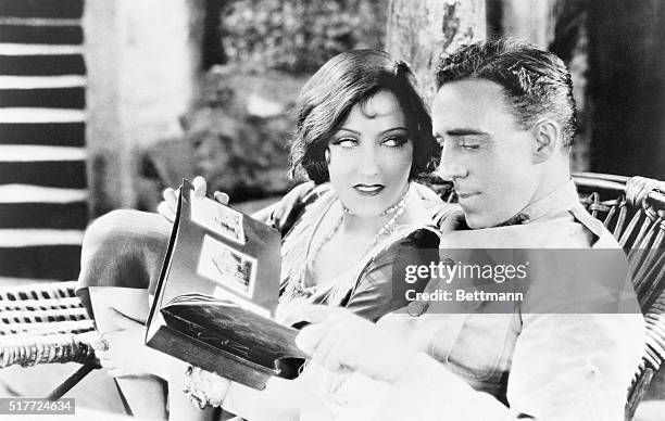 Gloria Swanson pays attention to director Raoul Walsh on the set during filming of "Sadie Thompson," which was released in 1928. Walsh started his...