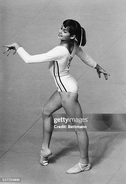 Romanian gymnast Nadia Comaneci smiles as she performs in the floor exercise competition at the 1976 Summer Olympics in Montreal, Canada. She would...