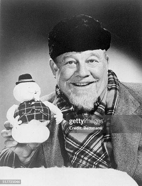 Burl Ives holds up the stop-motion snowman puppet of Sam, whose voice he provides in the TV Christmas special, "Rudolph the Red-Nosed Reindeer".