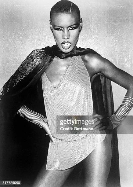 Disco star and model Grace Jones in a provocative outfit, complete with cape. Photograph, 1977.