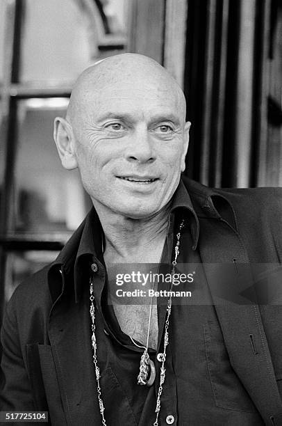 Actor Yul Brynner with his famous shaven head seen 9/11 onstage at the London Palladium press conference, when he was presented by Ross Taylor and...