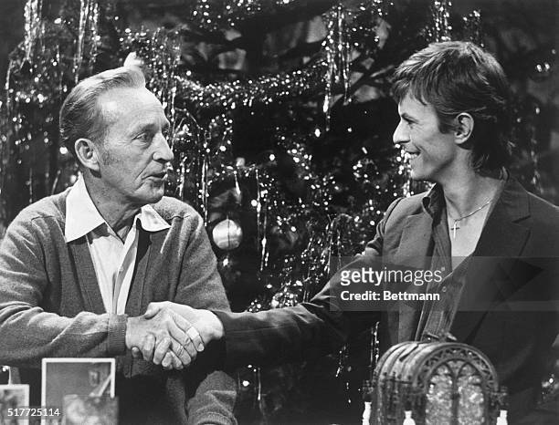 Bing Crosby and David Bowie shake hands during the taping of the television special "Bing Crosby's Merrie Olde Christmas". The two singers, of...