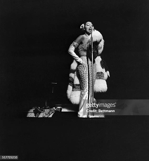 Entertainer Josephine Bakers sings during a performance at the Strand Theater on Broadway.