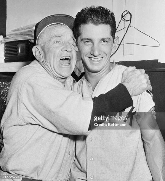 Philadelphia, PA: Yankee manager Casey Stengel gives second baseman Billy Martin a big hug in the New York squad's dressing room in Philadelphia,...