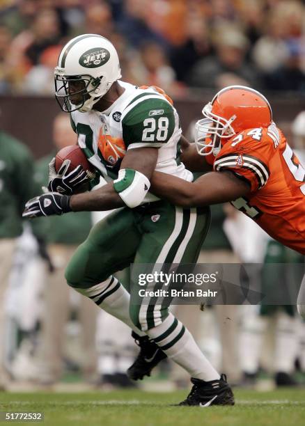 Running back Curtis Martin of the New York Jets takes linebacker Andra Davis the Cleveland Browns for a ride in the first quarter on November 21,...