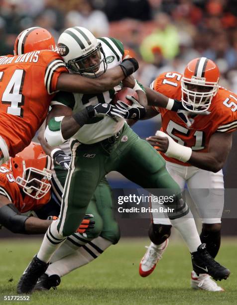 Running back Curtis Martin of the New York Jets starts off the game running as linebacker Andra Davis of the Cleveland Browns tackles him in the...