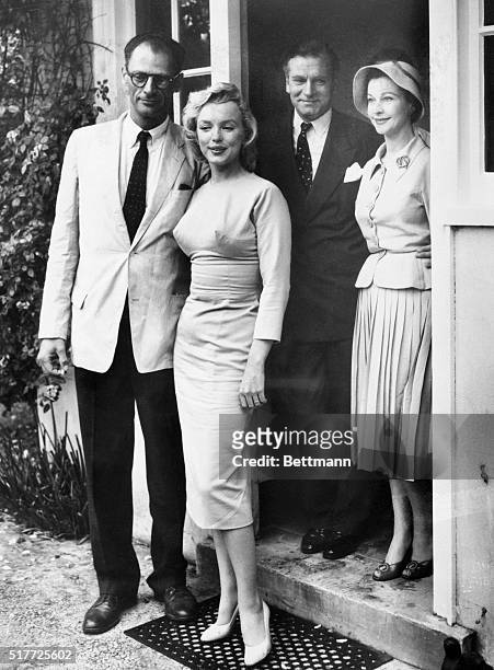 Surrey, England: Honeymooners Marilyn Monroe and Arthur Miller pose with Sir Laurence Olivier and his wife, Vivien Leigh outside of Lord Moore's...