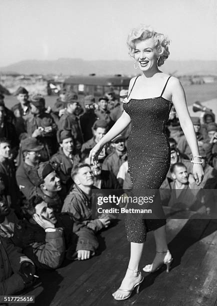 Korea: Heat wave, entertaining US troops in Korea. The walk and wiggle of Marilyn Monroe speak for themselves. The boys answer with whistles, cheers,...