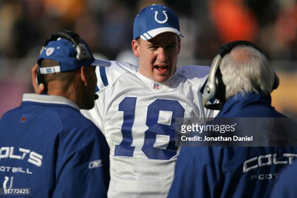 Quarterback Peyton Manning of the Indianapolis Colts talks with head coach Tony Dungy and offensive coordinator Tom Moore during the game against the...