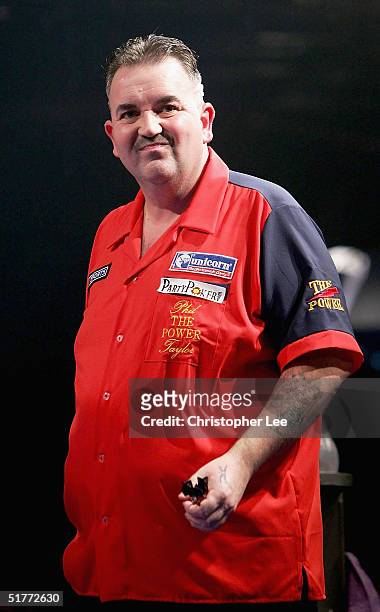 Phil Taylor looks pulls a face during the Showdown match between Phil Taylor and Andy Fordham at The Circus Tavern on November 21, 2004 in Purfleet,...