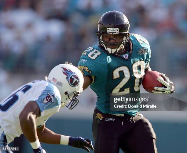 Running back Fred Taylor of the Jacksonville Jaguars runs against the defensive of the Tennessee Titans during the fourth quarter of their NFL game...