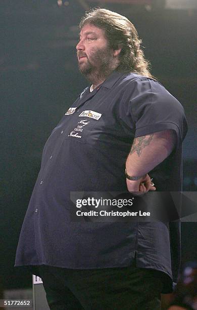 Andy Fordham waits his turn to throw during the Showdown match between Phil Taylor and Andy Fordham at The Circus Tavern on November 21, 2004 in...