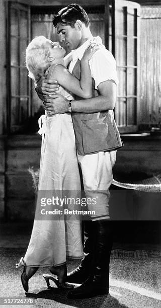 The terrific heat and blinding dust storms of indo-China provide tropical atmosphere for love scenes between Jean Harlow as Vantine and Clark Gable...