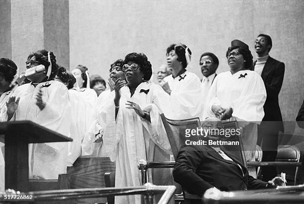 Guest preacher, Rev. Martin Luther King, Sr., listens as a choir group sings a hymn at the Canaan Baptist Church in Harlem.