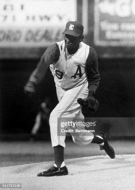 Leroy "Satchel" Paige, veteran of the Negro Leagues and various Major League and minor league teams, pitches the baseball as the starting pitcher for...